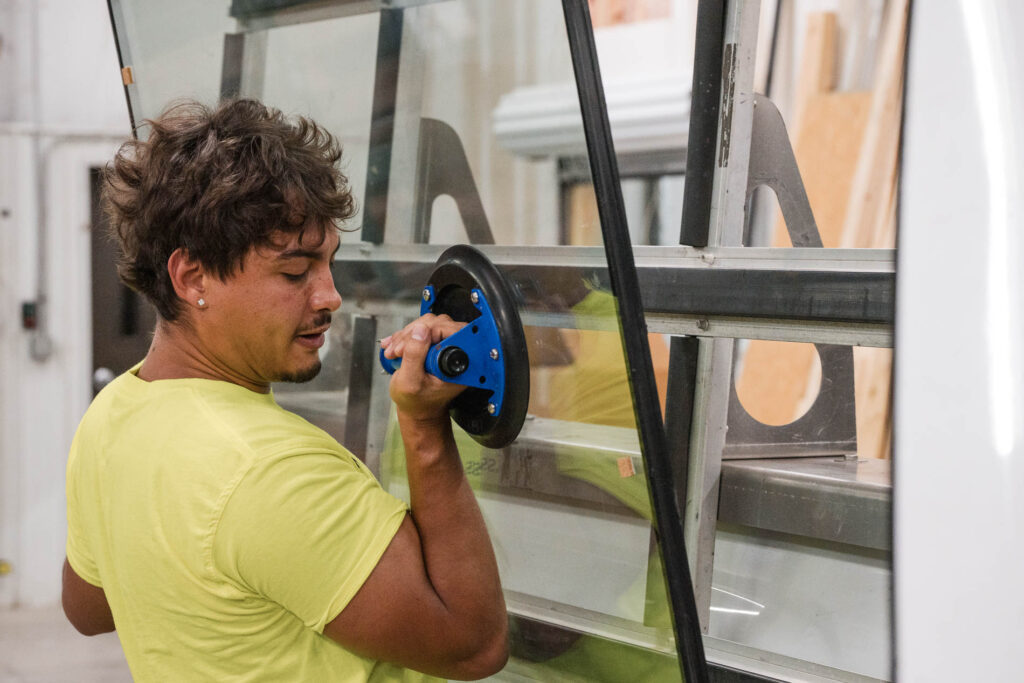 McIntyre Glass technician handling a glass panel with a suction lifter for a security glazing install